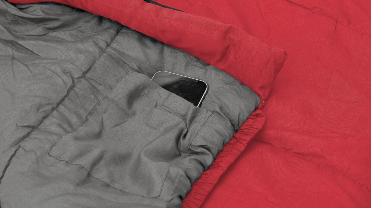 Outwell Campion Junior Sleeping Bag - Red feature image of pocket with mobile phone stored in it. 