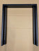A black metal mounting bracket or frame with two vertical arms and a horizontal top bar, photographed against a tan cardboard background.