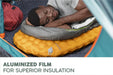 Bestway RidgeLite Insulated Regular Mummy Sleeping Pad Person sleeping on a camping mattress with 'Aluminized Film for Superior Insulation' text.