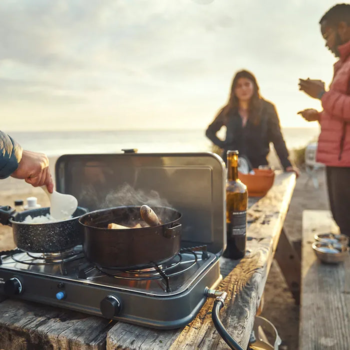 Cadac 2 Cook 2 Pro QR Twin Burner Camping Stove - lifestyle image, showing product being used to heat saucepans