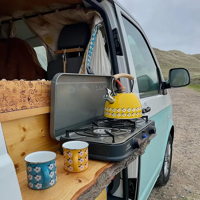 Cadac 2 Cook 2 Pro QR Twin Burner Camping Stove - lifestyle image, showing product being used to heat kettle