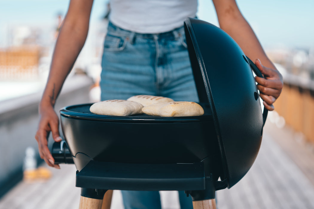 Cadac Citi Chef 40 FS Black - Urban & Camping Gas BBQ lifestyle image of the BBQ with bread grilling