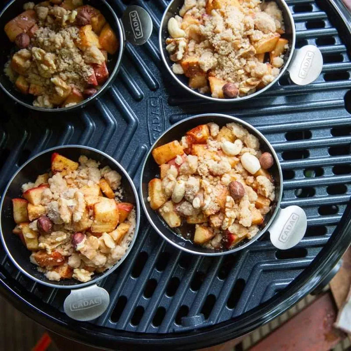 Cadac Tapas Dishes - Set of 4 - lifestyle image, showing tapas dishes containing food on top of a camping barbecue