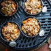 Cadac Tapas Dishes - Set of 4 - lifestyle image, showing tapas dishes containing food on top of a camping barbecue