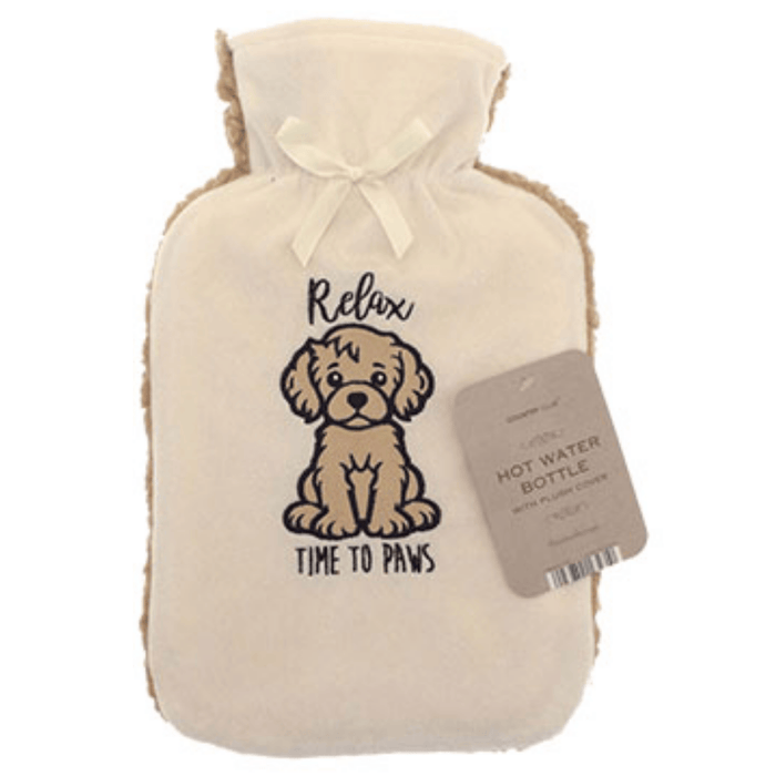 Country Club Relax Time To Paws 2L Sherpa Fleece Hot Water Bottle - main product image, showing a cream-colored hot water bottle with a plush cream cover featuring a brown cartoon dog illustration and the text 'Relax TIME TO PAWS'. A light brown paper tag is attached to the side, and the bottle is photographed on a clean white background.