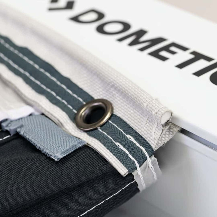 Dometic Rally 200 Poled Caravan Awning - 2026 Model - product image, showing close-up of awning kador strip with eyelet, slid into vehicle rail 