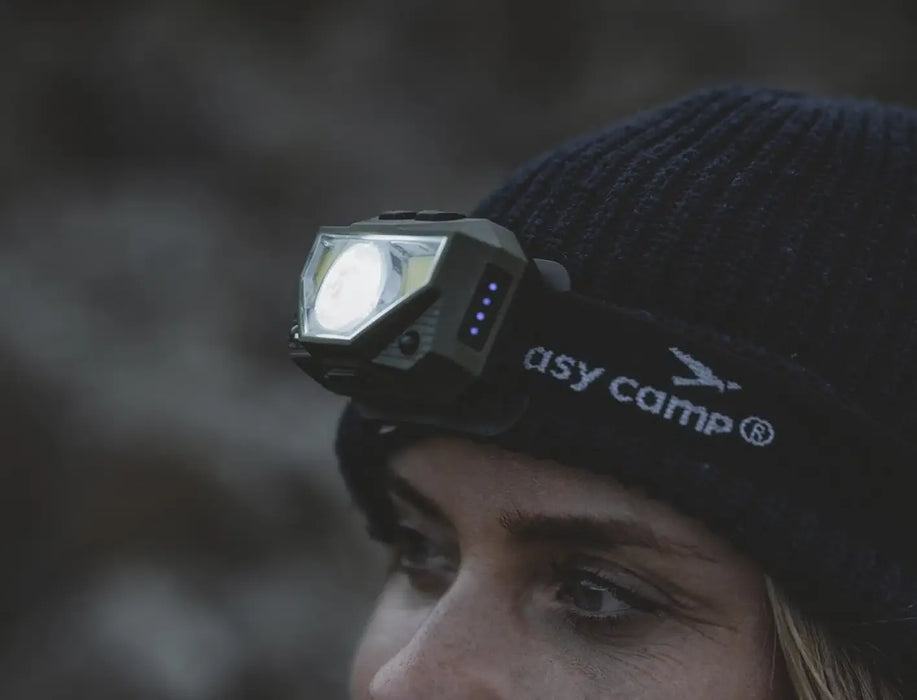 Easy Camp Crowberry Rechargeable Head Torch - lifestyle image, showing close-up of person wearing lit head torch