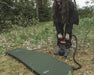 Easy Camp Double Action Manual Air Pump - lifestyle image, showing person using pump to inflate camping mattress