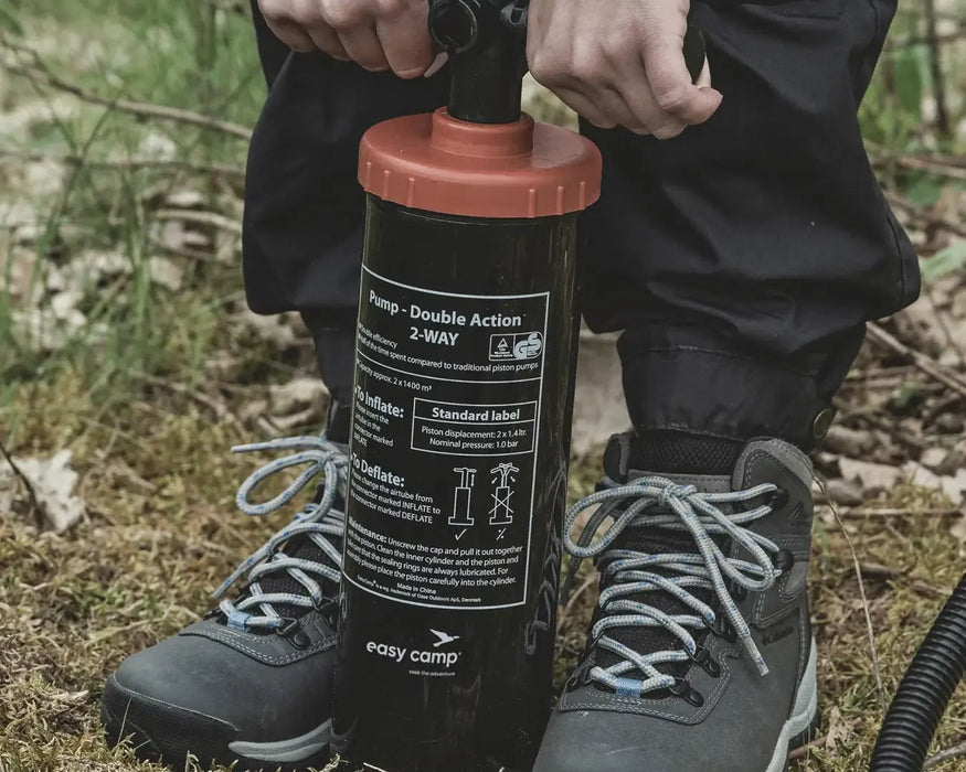 Easy Camp Double Action Manual Air Pump - lifestyle image, showing close-up of person using pump
