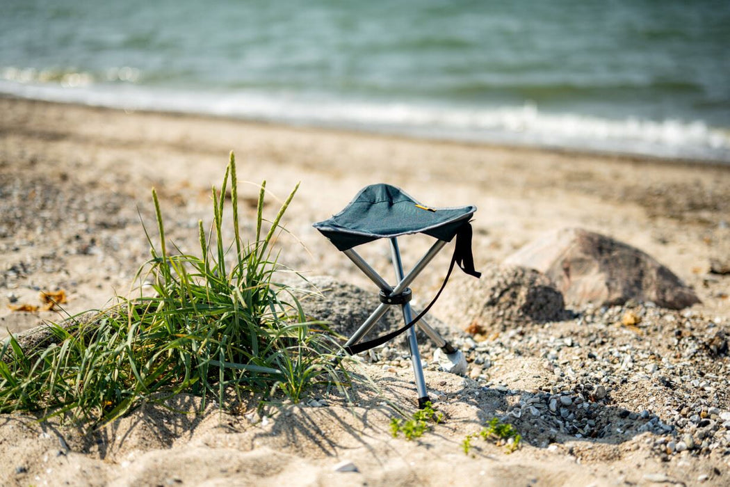 Easy Camp Marina Lightweight Aluminium Stool lifestyle image of stool by a shore line.