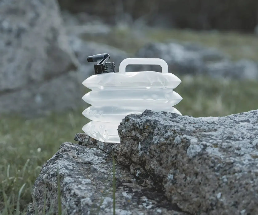 Easy Camp Nettle Folding 3 Litre Camping Water Carrier - lifestyle image, showing carrier outdoors