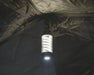 Easy Camp Wintergreen Lantern - lifestyle image, showing lantern hanging by hook inside tent