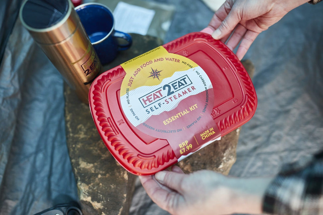 Heat 2 Eat, Medium Self Steamer Red 'Heat 2 Eat' self-steamer kit held by a person with outdoor items in the background
