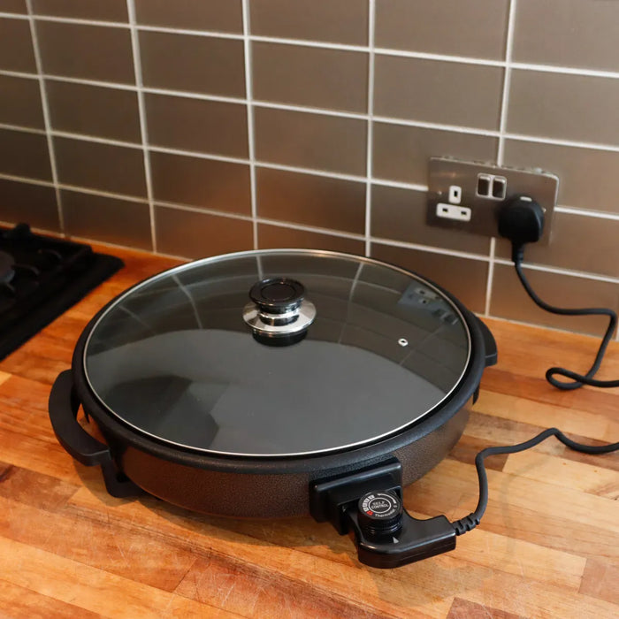 Leisurewize Electric Skillet 38cm - lifestyle image, showing product plugged into home electrical socket