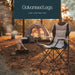 Leisurewize High Back Padded Folding Camping Chair with Cup Holder - lifestyle image, showing chair in foreground positioned on ground in woodland with tent and small fire positioned behind to the left