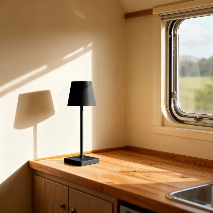 Leisurewize Lucia Rechargeable Table Lamp – Black - lifestyle image, showing lamp sat on wooden worktop inside caravan