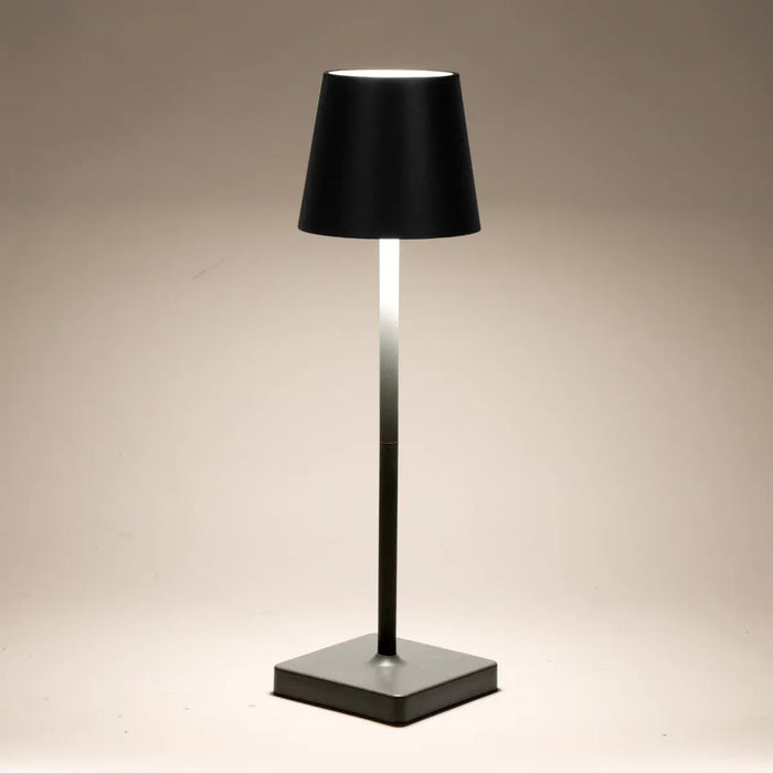 Leisurewize Lucia Rechargeable Table Lamp – Black - product image, showing lamp illuminated against beige background