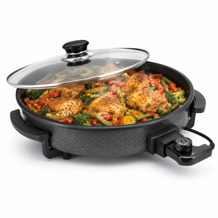Leisurewize Multi-Functional Electric Skillet / Cooker 1500W - main product image, showing a round electric skillet with a textured black non-stick coating, a clear glass lid, and a side dial, filled with cooked chicken and vegetables on a white background.