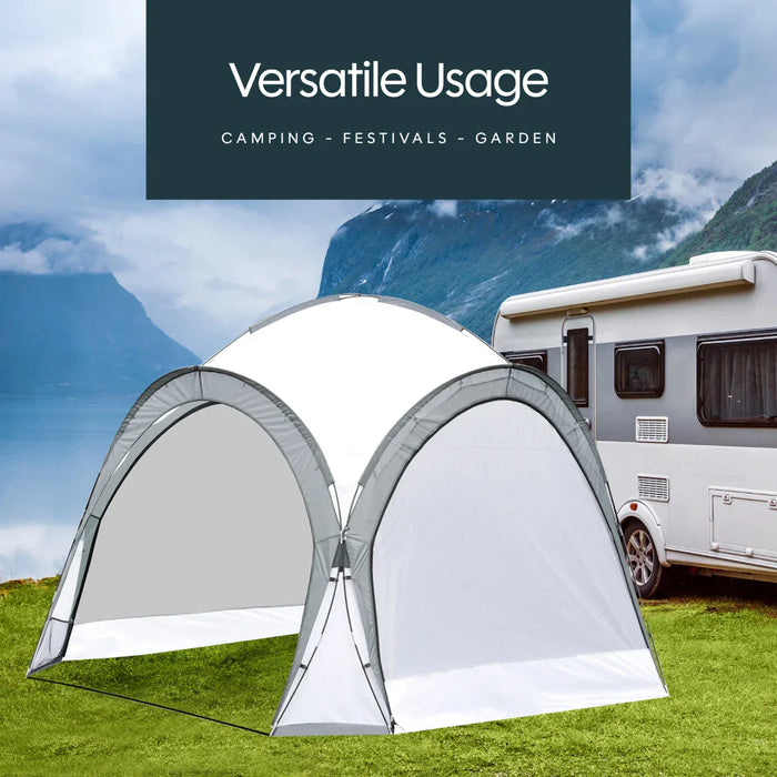 Leisurewize Outdoor Retreat Quick Erect Camping Shelter 3.5m - product infographic showing white and gray pop-up car camping shelter tent pitched on green grass next to a white motorhome, with a dark teal text banner at the top reading 'Versatile Usage' and 'Camping - Festivals - Garden'.