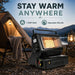 Leisurewize Portable Outdoor Butane Gas Heater 1.3kW - lifestyle image, showing a portable black outdoor heater with a glowing orange flame visible through the front grill, shown on a campsite at dusk beside a tent, chair with a blanket, and lantern. Large text at the top reads 'STAY WARM ANYWHERE' with feature icons for 1.3kW heat and adjustable warmth