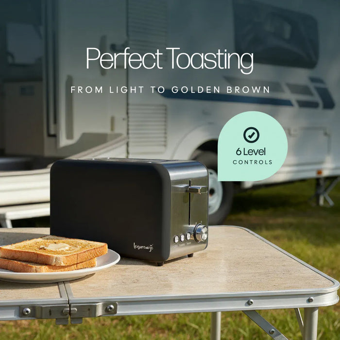 Leisurewize Sleek 2-Slice Toaster Black 850W - product image, showing a black toaster sitting on a folding camp table outdoors with toast on a plate in the foreground and an RV blurred in the background. Text reads 'Perfect Toasting' and 'FROM LIGHT TO GOLDEN BROWN,' with a badge saying '6 Level Controls.