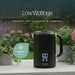 Leisurewize Sleek LED Kettle Black 1.7L 1000W - product image, showing a black electric kettle on a outdoor surface surrounded by potted plants, with garden scenery in the background, with text above: 'Low Wattage - perfect for caravans & camping'