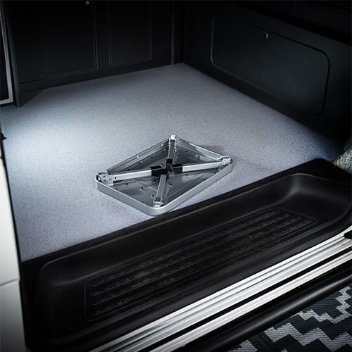 Maypole Single Steel Folding Caravan Step - product image, showing step folded flat in vehicle, laid on its upper surface