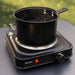 Mestic MKT-120 Single Electric Camping Hotplate - lifestyle image, showing the hotplate being used outdoors to heat a saucepan