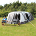 Outdoor Revolution Airedale 6S Inflatable Tent 2024 - 6 Berth Tunnel Tent feature image of tent pitched on campsite. right side door unzipped and half front door rolled back with guy sitting out front on chair with table and empty chair on other side