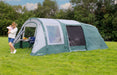 Outdoor Revolution Atom 600 - main product image, showing mother and child outside tent pitched in field surrounded by trees, with some furniture visible inside