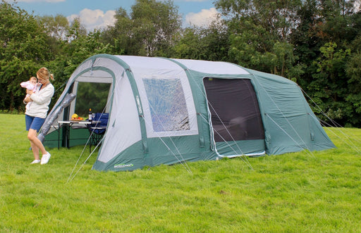 Outdoor Revolution Atom 600 - main product image, showing mother and child outside tent pitched in field surrounded by trees, with some furniture visible inside