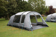Outdoor Revolution Camp Star 500 DT- Poled 5-Berth Tunnel Tent Bundle feature image of the tent pitched on a green grassy campsite. this view is of the left side of the tent with the two front doors open and all the curtains open.