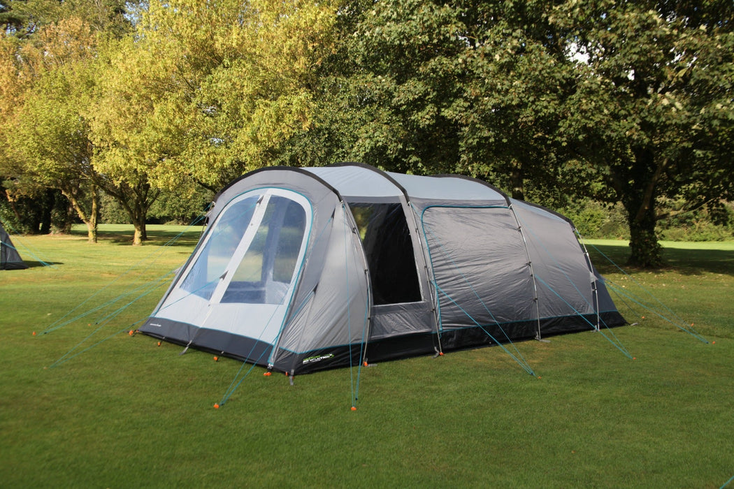 Outdoor Revolution Camp Star 500 DT- Poled 5-Berth Tunnel Tent Bundle feature image of the tent pitched on a green grassy campsite. right side angle with all doors zipped up and all curtains open