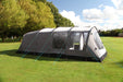 Outdoor Revolution Camp Star 600 PC DT- Polycotton Poled 6-Berth Tunnel Tent Bundle image of the tent pitched on a campsite surrounded by green trees. full left side view with teal guylines pegged into ground