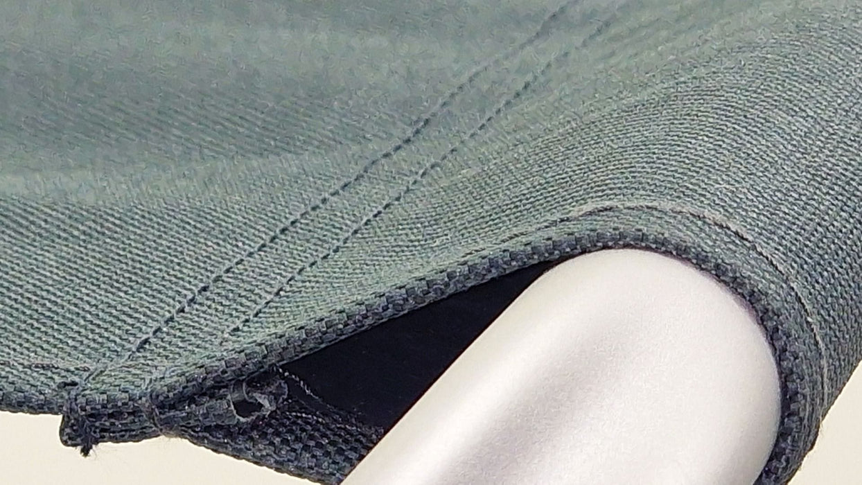 Close-up of a grey fabric sleeve on a stool leg