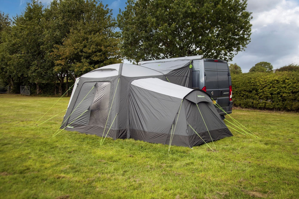 orda1623-03 Camping tent attached to a van in an outdoor setting with trees and grass.