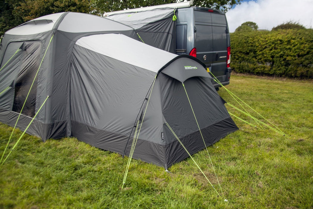 orda1623-06 Gray caravan awning extended on grass with a van in the background