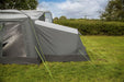 orda1623-07 Gray camping tent with a flysheet on a grassy field with trees in the background