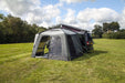 orda1640 Outdoor Revolution Cayman DT Awning attached to van with a large in a grassy field with trees in the background