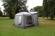 Outdoor Revolution Cuda (F/G) Low Drive Away Awning Feature image of the awning pitched on campsite grass with green trees surrounding. right side view  with window showing inside the awning. pitched on frame so you can see the cowl up. all doors zipped up