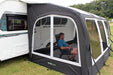 Outdoor Revolution Eclipse Pro 380 Mesh Door Side Panel - lifestyle image, showing person sat inside Eclipse Pro awning connected to caravan, showing door panel fitted and closed