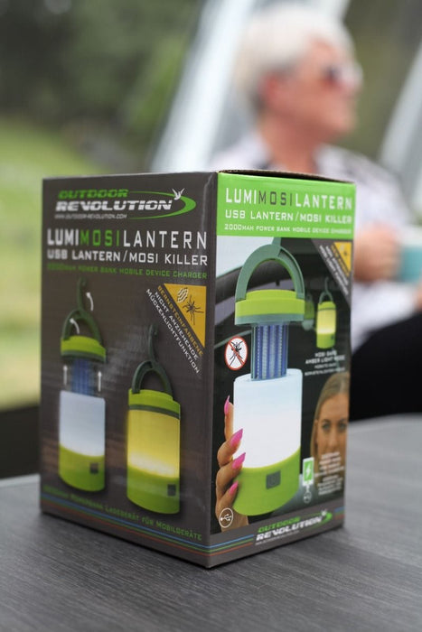 Outdoor Revolution Lumi-Mosi Recharageable Lantern & Mosquito Killer - lifestyle image, showing product packaging box sat on table outside with person sat in background