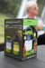 Outdoor Revolution Lumi-Mosi Recharageable Lantern & Mosquito Killer - lifestyle image, showing product packaging box sat on table outside with person sat in background