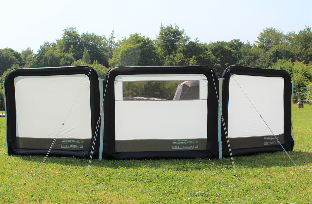 Outdoor Revolution Oxygen Pro 3 Panel Inflatable Windbreak 130 x 490cm feature image showing the three panels with logo on bottom right of each. pitched on campsite with tents in background. 