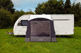 Outdoor Revolution Porch Pro 260 Inflatable Caravan Awning - product image, showing awning pitched and attached to caravan in a field surrounded by trees, shown from front head-on angle