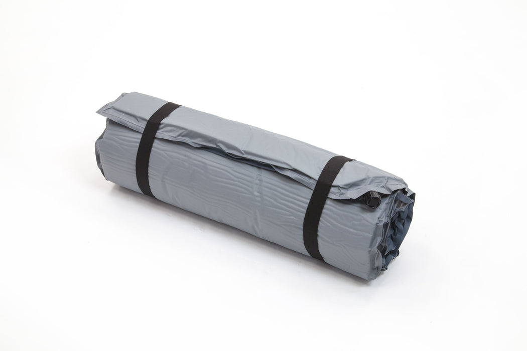 A grey rolled-up sleeping pad or mat secured with two black straps, photographed on a clean white background.