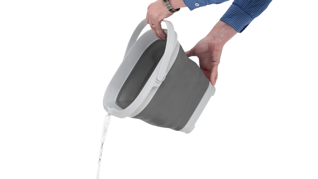 Outwell 9 Litre Collapsible Square Bucket - product image, showing person tipping water out of bucket