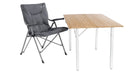 Outwell Alder Lake Folding Camping Chair feature image showing chair  height against wooded topped table
