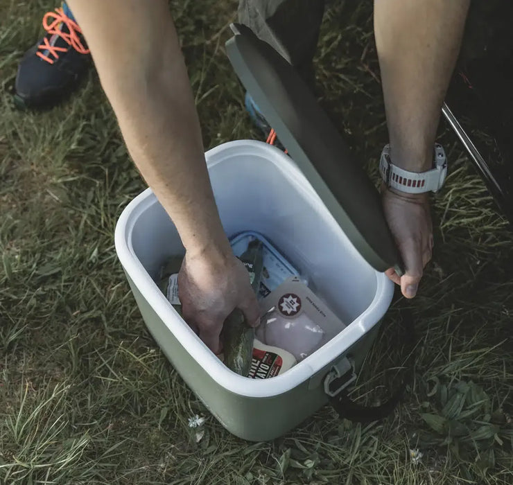 Outwell Arctic Poppy 14 Litre Camping Coolbox - lifestyle image, showing person reaching into coolbox with food products inside