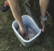 Outwell Arctic Poppy 14 Litre Camping Coolbox - lifestyle image, showing person reaching into coolbox with food products inside